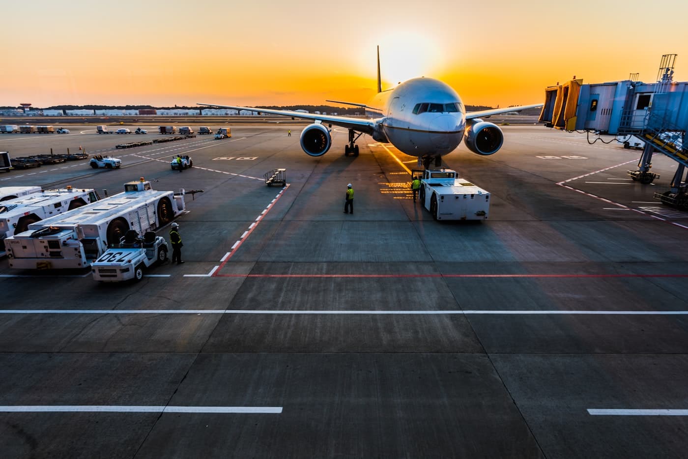 Airplane at the gate under a golden sunset